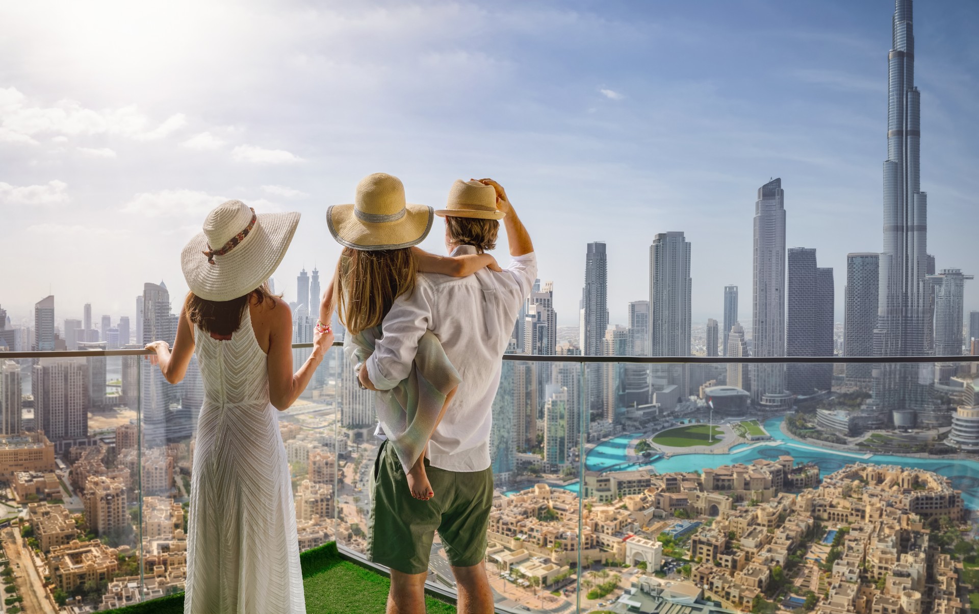 A family on a city break enjoys the view over the skyline of Dubai